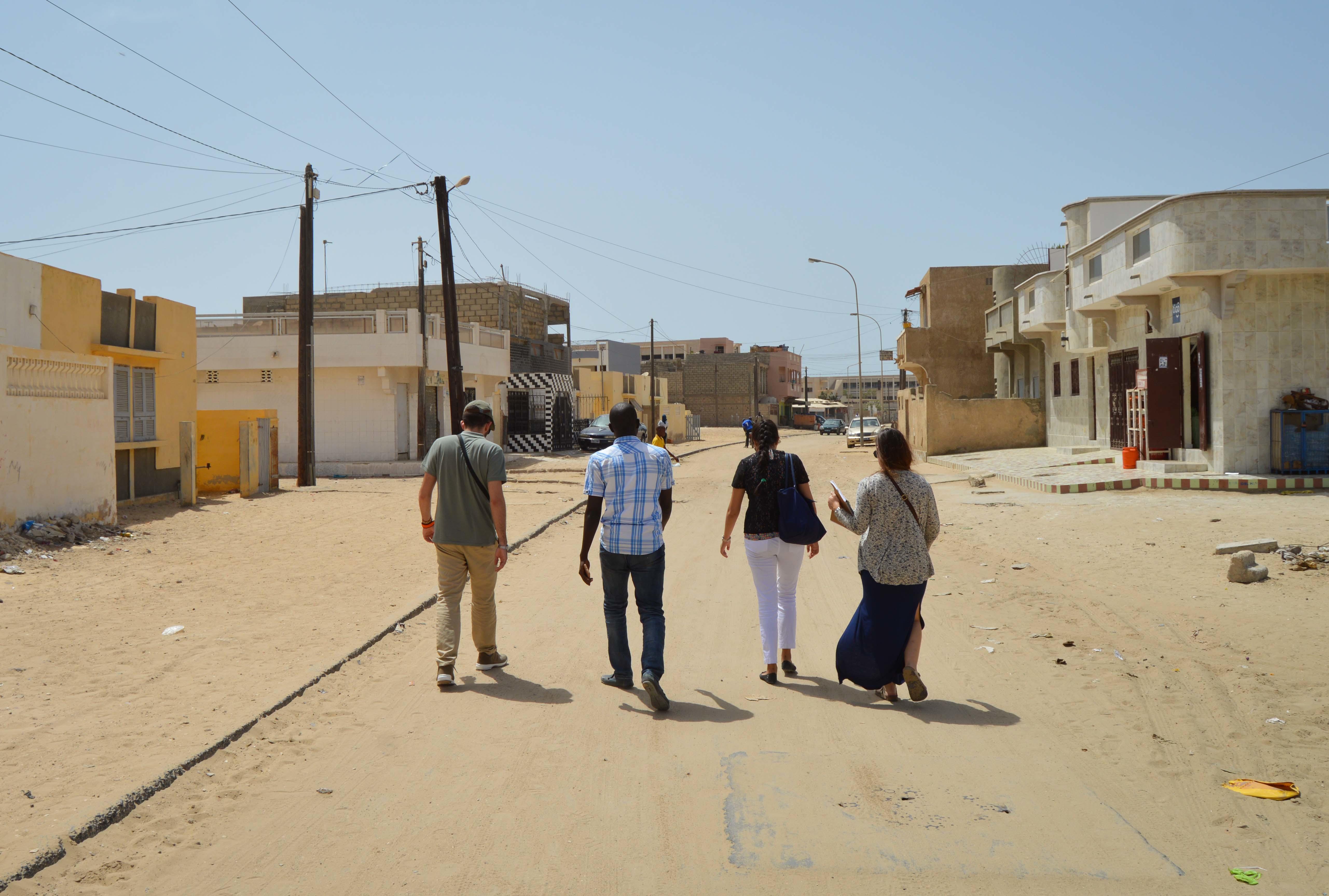 Projects Abroad interns walk through a local town as part of their Human Rights work experience in Senegal. Students walk through a local community during their Human Rights internship in Senegal.
